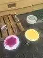 Using stencils to spray paint designs on buckets