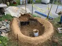 Image 4: Nearly finished berm with clay slurry layer applied.