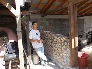 CCAT greenshed north wallCordwood and mortar wall of CCAT's Greenshed