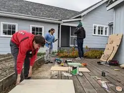 (Left to right) Everett Brown, Jordy Lopez, Sasha Cahill over the Busy Board setup
