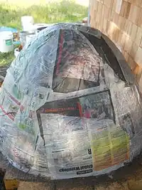 Fig.13 After the sand dome was created, we covered it with Newspaper. When we excavate the sand from the finished oven the newspaper will be an indicator of when we reached the inside layer