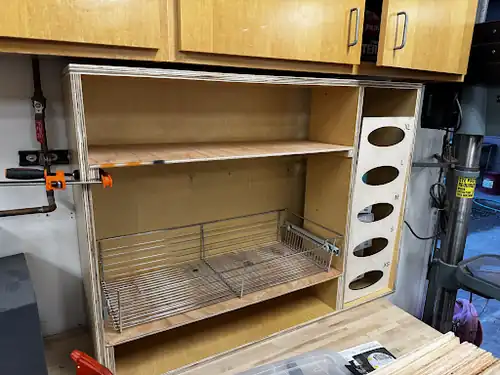 Constructing the shelves for the PPE cabinet.