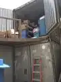 A shipping container that is used to store medical supplies for Ti Kay.