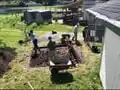 Katie and Rotary Club volunteers digging a leveled six inches deep for the foundation of the storage tank