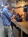 Fig 3: Jerome (HSU student) filing one of the beams in John's shop.