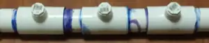 Three sections of PVC joined by three T-joints.