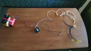 A collection of wires coming off of a lantern battery.