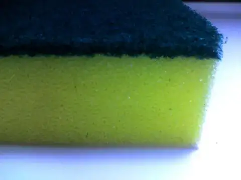 A yellow sponge with a green scourer patch on top