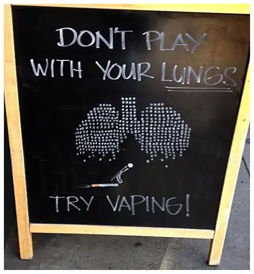 A sign outside of a vape shop suggesting vaping is safer than smoking.