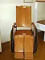 Wooden wheelchair dating to the early part of the 20th century