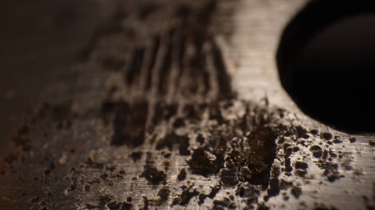 a close up of pitting near one of the bolt holes