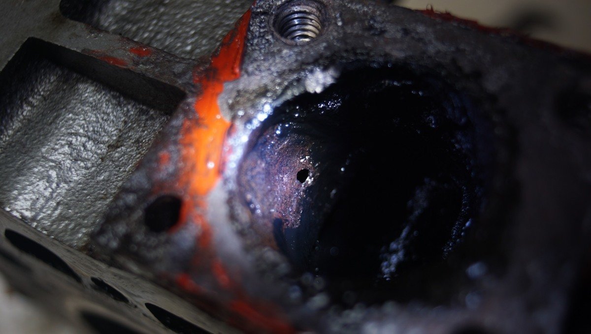 A photo of a pinhole inside the body of a Yanmar2gm diesel engine 