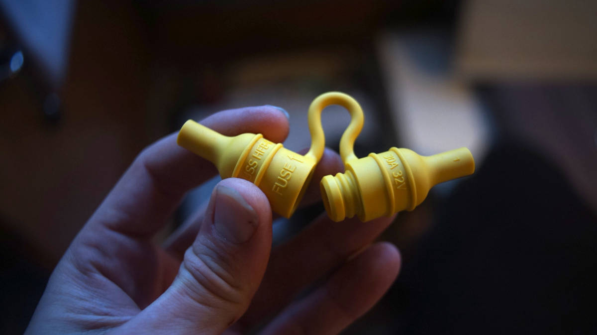 a yellow waterproof inline fuse box