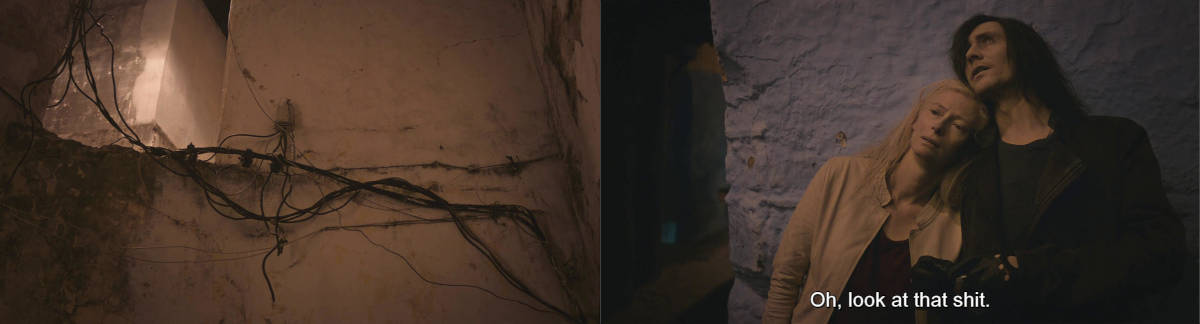 two characters stare at terrible wiring on a building and say, look at this shit