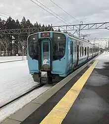Aoimori 703 series two-car electric multiple unit (EMU) arriving at a train station