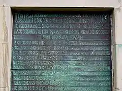 A discoloured brass plaque showing the names of those local men killed in the First World War