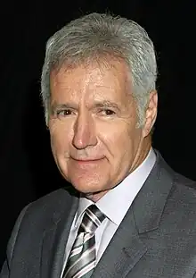 Trebek in 2012 wearing a dark grey suit