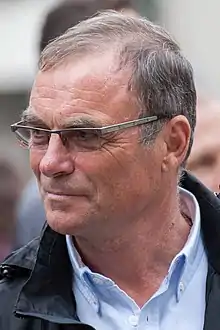 Color photograph of Hinault, looking to the left, wearing glasses