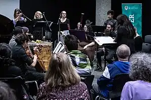 student performers with conductor