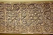 Carved stucco panel from the city of Samarra. Floral pattern with Abbasid geometric designs, grapes, vines, and ears of pine cones. third Islamic century AH (9th century)