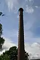 The  120-foot (37 m) tall chimney, brick with oversailing caps