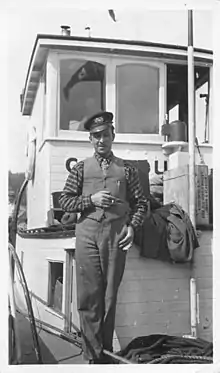 Emrys Jones aboard the tug boat Canadusa on the Athabasca River in 1928
