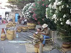 Making wickerware in main square of Cabanes