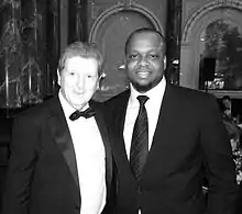 A formally-dressed Sanomi and Roy Hodgson, a middle-aged man