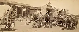 Plate photograph of a train of immigrants passing through San Angelo in 1885