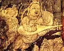 Kinnara with kachchapa veena, part of Bodhisattva Padmapani painting in Cave 1.