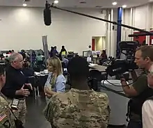 Laura Sullivan interviewing a FEMA manager after Hurricane Harvey in 2017 at the Houston Convention Center