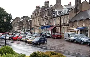 Looking west along Front Street (B6341), in the foreground, and High Street, in the background, running parallel to Front Street.