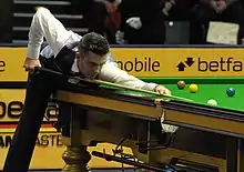 Selby playing a shot