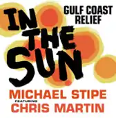 A white background with several orange and yellow circles and the words "IN / THE / SUN" written in black across the middle. The phrase "GULF COAST / RELIEF" is written in the top right in black script and the bottom of the cover reads "MICHAEL STIPE / FEATURING / CHRIS MARTIN" in black and red.