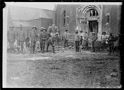 H1075. New Zealand Pioneers fill a mine crater outside a church in Beauvois, France, 15 October 1918. Photo: Henry Armytage Sanders