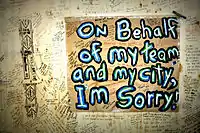 A sign on a wall with other messages written on the day following the riot