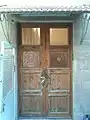 Wooden door entrance to first floor decorated with magen david (star of David) and the word Zion in Hebrew.