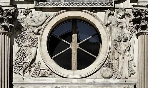 Renaissance medallion-like oculus on the west facade of the Cour Carrée of the Louvre Palace, with figures of war and peace, sculpted by Jean Goujon and designed by Pierre Lescot, 1548