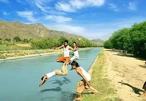 People enjoying swimming in the Pehur High Level Canal