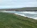 View eastwards over Porth Trecastell cove from the side of Barclodiad y Gawres