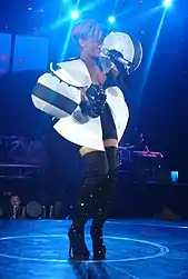 A woman with red hair, wearing an electro blue skirt.