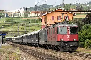 Red locomotive with long string of carriages