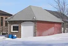 One-story brick garage with hip roof