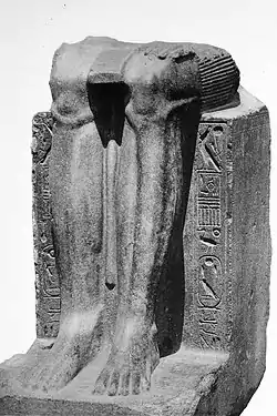 Remains of a statue of the Twelfth Dynasty reappropriated by Hyksos ruler Khyan, with his cartouche inscribed on the sides over an erasure.