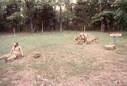 Caveman and a saber-toothed cat (1988 photograph).