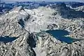 Aerial view of Glacier Peak in upper left, Eagle Cap shaded in upper right,Prospect Lake lower left, Glacier Lake to right.