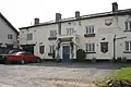 White painted building with pub sign saying The Lamb Inn