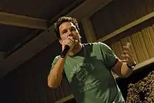 Cook speaking into a microphone