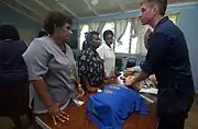 Aboard the Military Sealift Command (MSC) hospital ship, USNS&nbsp;Mercy, YN3 Dan S. Konzek demonstrates how to properly locate the carotid pulse to nurses from the Modilion General Hospital in Madang, Papua, New Guinea. USNS Mercy had just completed tsunami and earthquake relief operations in Indonesia (2005).