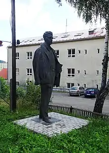 Photograph of statue of Julius Fučík surrounded by trees in a public square